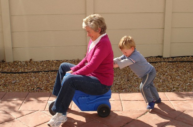 Child pushing grandmother on plastic tricycle (credit: Catherine Scott-Matti/CC BY-SA 2.0)